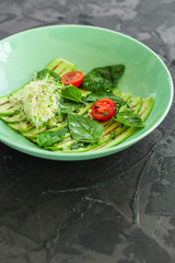 zucchini grill with tomatoes and cream cheese, sauce and micro-greens (warm salad appetizer). food background. copy space