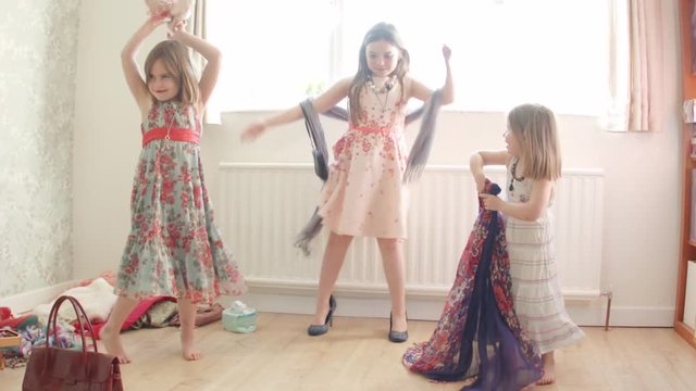 Pre teen caucasian girl dancing and playing dress up themes of siblings pretend dress up carefree