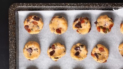 Healthy food concept raw dougn of Homemade Trail Mix organic Whole grains Energy cookies in baking pan with copy space
