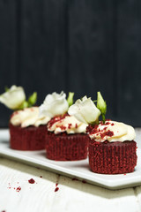 Red velvet cupcakes red velvet with cherry jam on white and black wooden backgrounds