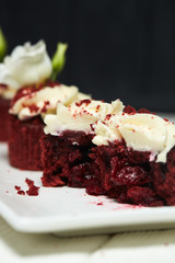 Red velvet cupcakes red velvet with cherry jam on white and black wooden backgrounds