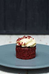 Red velvet cupcakes red velvet with cherry jam on white and black wooden backgrounds