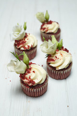 Red velvet cupcakes red velvet with cherry jam on white and black wooden backgrounds