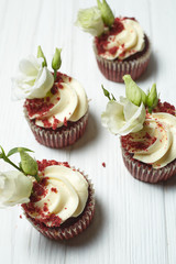Red velvet cupcakes red velvet with cherry jam on white and black wooden backgrounds