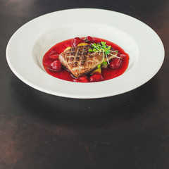 duck breast, vegetables, berry sauce and microgreen (main dish). food background. top view