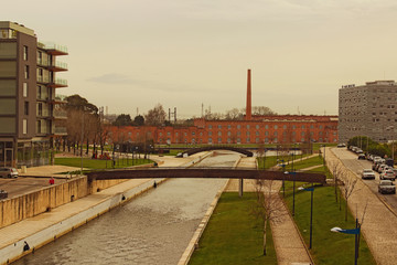 Fototapeta na wymiar Aveiro, Portugal- December 31, 2015: Stunning landscape view of historical and modern buildings. The main channel of the city of Aveiro, known as the Venice of Portugal