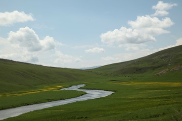 Fototapeta na wymiar Sunny summer landscape with river.Green hills,fields and meadows