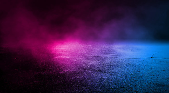 Background empty street at night. Wet asphalt, reflection of neon multi-colored light. Fog, smoke