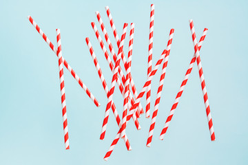Fototapeta premium Colorful drinking straws for beverage on a bright background. Birthday festive cheerful background.