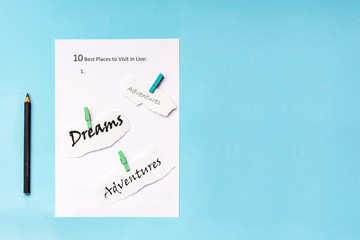 The inscription on a white sheet of A4: 10 best plases to visit in live. On a blue background.