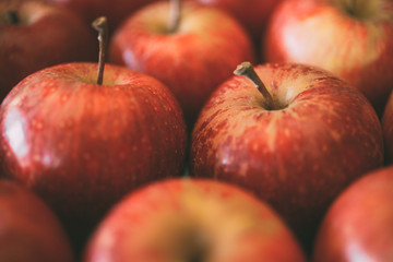 Macro view of red apples as background.