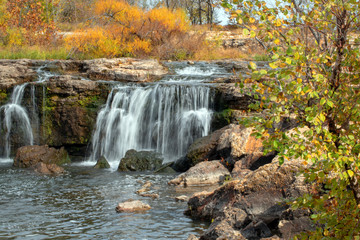 A beautiful tranquill scene in the Ozarks with a waterfall on a pretty autumn day.