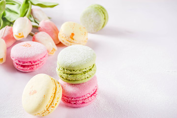 Classic colorful macarons. Six pink, yellow and green macaron cookies top view copy space