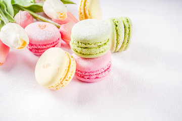 Classic colorful macarons. Six pink, yellow and green macaron cookies top view copy space