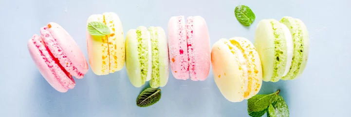 Poster Classic colorful macarons. Six pink, yellow and green macaron cookies top view copy space © ricka_kinamoto