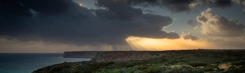 View of the lighthouse and cliffs at Cape St. Vincent in Portugal at storm.