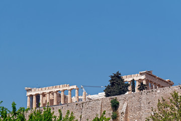 Athens, Parthenon ancient Greek temple, view from the street under the hill, plenty of space for...