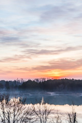 Obraz premium Stunning landscape of lake and sunrise in sky with clouds. Sky view.