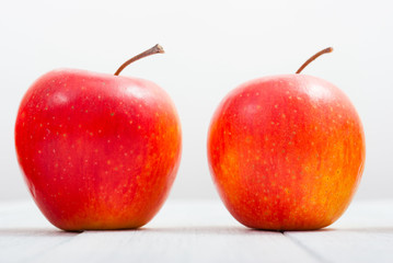 apple fruits in a row, white wooden table background