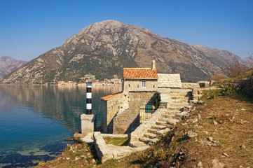 Fototapeta na wymiar Ancient religious architecture. Catholic Church of Our Lady of the Angels on the coast of Kotor Bay. Montenegro, Adriatic Sea