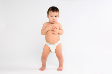 baby boy in diapers on white background, Infant baby boy in diaper crawl happily looking at camera isolated on white background, Infant baby boy in diapers standing on a white background