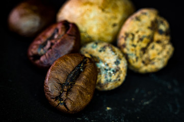 Brown roasted coffee and cocoa beans on black background, close up, macro