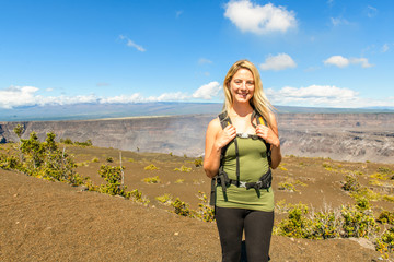 The Hawaii volcano tourist woman at Halemaumau crater in Kilauea caldera in Hawaii Volcanoes National Park