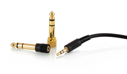 3.5mm 1/8 stereo headphone jack, 3-pole mini-stereo headphone plug or phone connector with two 6.35 mm 1/4 male to 3.5mm 1/8 female gold plated headphone audio adapters isolated on white background