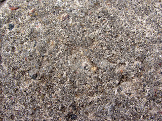 concrete block with a large number of fraction of river sand macro closeup texture