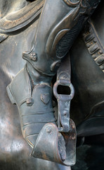 .knightly boot in the stirrup of a horse while riding