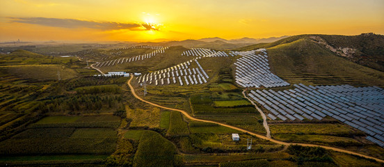 Aerial photo of solar photovoltaic panel scene in the sunset