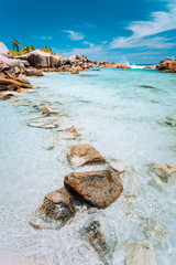 Shallow clear turquoise water of paradise beach Anse Cocos on the Seychelles. Vacation background