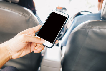 Blank screen smartphone use in hand sitting in taxi