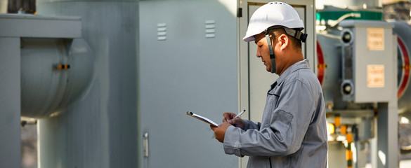 Asian engineer recording electrical box data for power station © jeson
