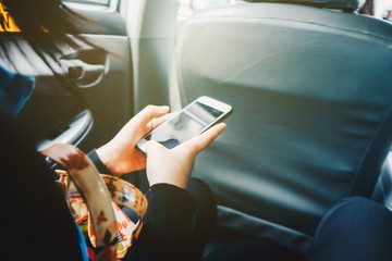 Blank screen smartphone use in hand sitting in taxi