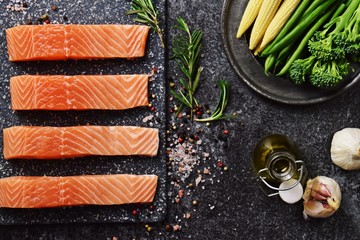 Raw salmon filet on dark slate background, wild atlantic fish 