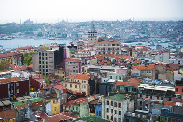 Fototapeta na wymiar Istanbul, Turkey - October 9, 2017: A view of the houses and Galata tower in Istanbul