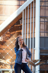 Fototapeta premium teen girl having a mobile phone talk in a large metropolis