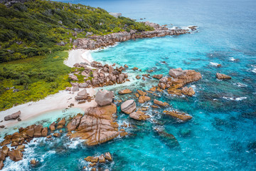 Aerial view of Seychelles tropical Marron beach at La Digue island. White sand beach with turquoise ocean water and quaint granite rocks. tropical paradise