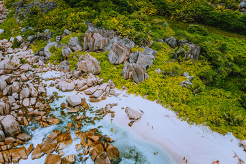 Aerial view of Seychelles tropical Marron beach at La Digue island. White sand beach with turquoise ocean water and granite rocks