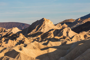 Looking out over the rocky landscape of Zabriskie Point in Death Valley, with evening light