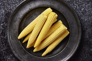 Baby corn isolated on dark background