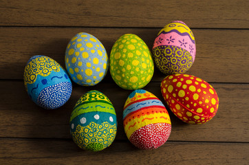 Colorful decorated easter eggs on wooden background. Easter decoration
