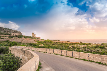 Malta: Scenic road to Ghar Lapsi tower with hilly landscape and sea