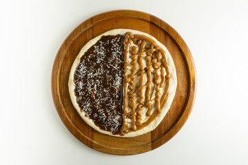 Sweet pizza with chocolate and sweet milk on white background
