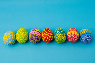 Colorful decorated easter eggs on blue background. Easter Day decoration