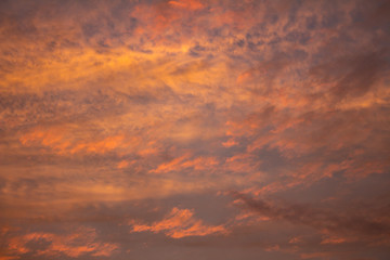 Small clouds of pink and orange colors at dawn.