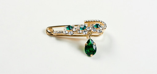 Green jewelry brooch with white background