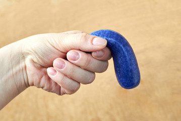 A toy made of plasticine in the hand of a woman, the theme of sexual dysfunctions, the toy...