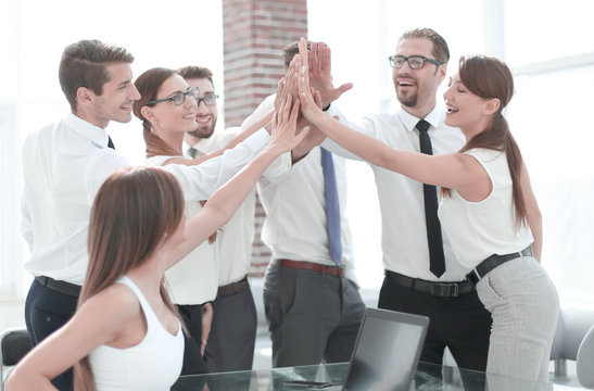 young business team giving each other high five
